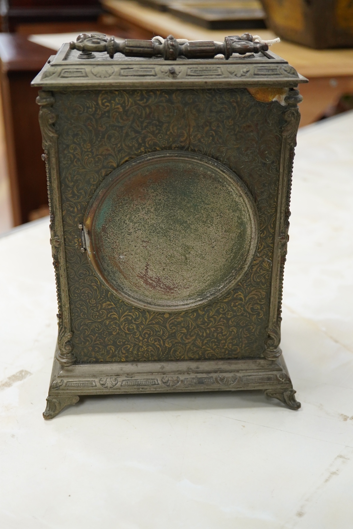 A brass overlaid mantel clock with key and pendulum, striking on a bell, 26cm high